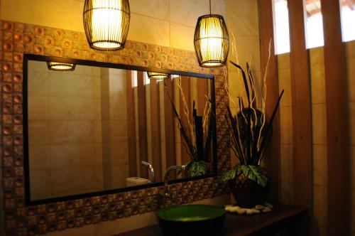 a bathroom with a sink and a mirror and lights at Marina Oriental Hotel in Butterworth