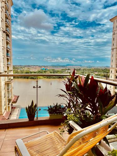 a balcony with a view of a swimming pool at LoFF Suite River View 2 Bedroom at Kuching Riverine Resort in Kuching