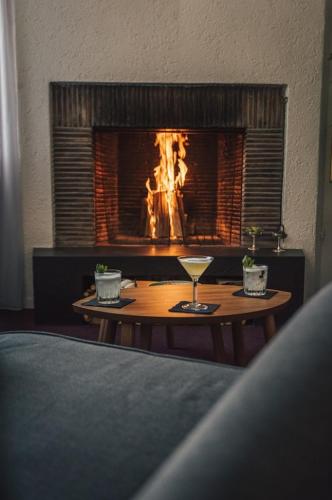 a table with a wine glass in front of a fireplace at Komplettes Hotel mit 10 Zimmern in Bad Ragaz