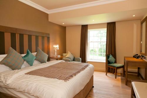a hotel room with a large bed and a window at Spa Hotel at Ribby Hall Village in Wrea Green