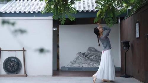 a woman standing in front of a wall at Dasein Youlan Hotel-Near the Forbidden City, Tiananmen Square, Guijie Street, Beihai Park, Jingshan Park, and Yonghe Temple in Beijing
