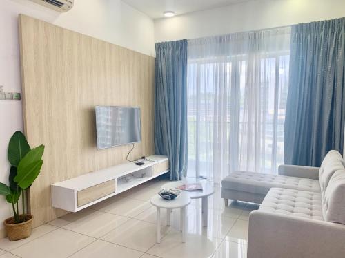 a living room with a couch and a tv at Deco Home @ Imago The Loft in Kota Kinabalu