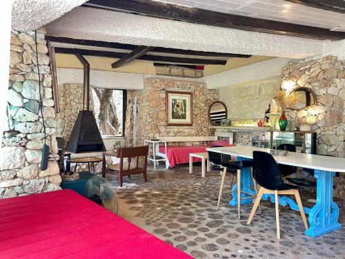 a living room with a table and chairs and a piano at Limonaia in Salento in Marittima