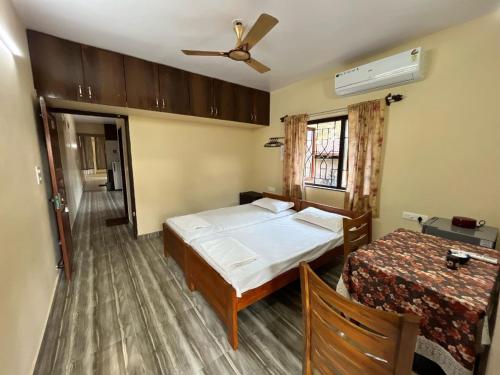 a bedroom with a bed and a ceiling fan at D 'SOUZA HOLIDAY HOME in Benaulim