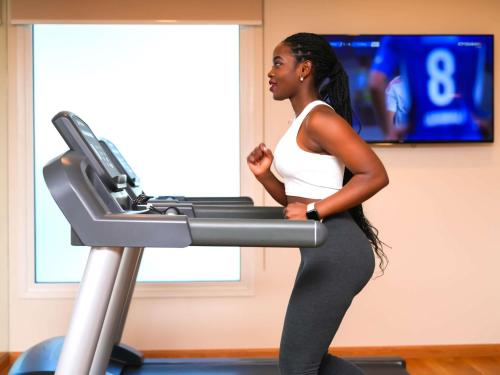 a woman running on a treadmill at Ibis Styles Dragon Mart Dubai in Dubai
