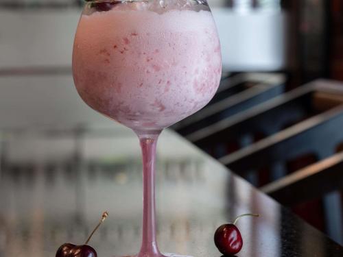 a martini glass with a cherry on a table at Ibis Styles Dragon Mart Dubai in Dubai