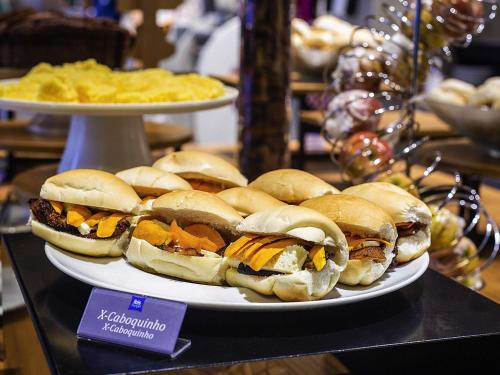 a plate of sandwiches on a table with chips at ibis budget Manaus in Manaus
