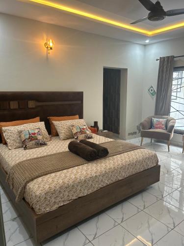 a bedroom with a large bed in a room at VELVET VIBES VILLA Near Islamabad Airport in Dhok Sandemār