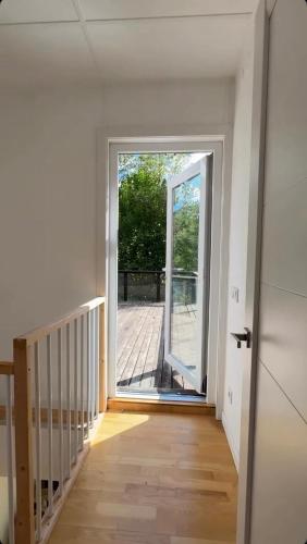 an empty hallway with a door leading to a deck at ForestSide in Grebenov