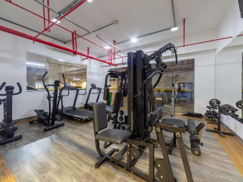 a gym with several tread machines in a room at ibis Manaus Aeroporto in Manaus