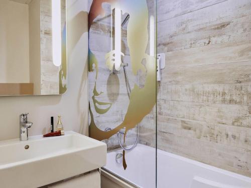 a bathroom with a sink and a toilet and a shower at Ibis Styles Hyères Rooftop & Spa in Hyères