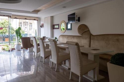 a dining room with a long table and chairs at Kumsal Butik Otel in Istanbul
