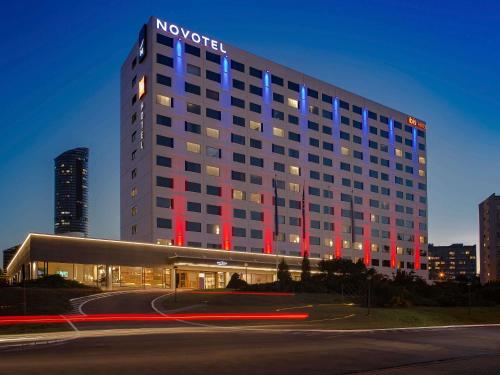 a hotel building with red and blue lights on it at Novotel Wrocław Centrum in Wrocław