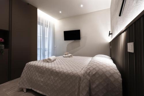 a bedroom with a bed with two stuffed animals on it at Valentino Rooms in Ravenna
