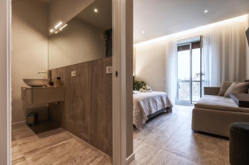 a living room with a bed and a couch at Valentino Rooms in Ravenna
