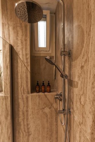 a bathroom with a shower with two bottles on a shelf at Valentino Rooms in Ravenna