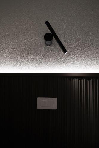 a black cigarette sitting on top of a wall at Valentino Rooms in Ravenna