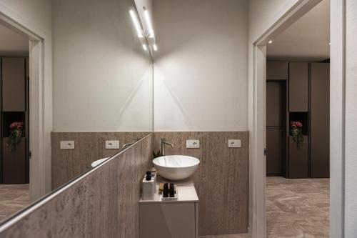 a bathroom with a sink and a mirror at Valentino Rooms in Ravenna