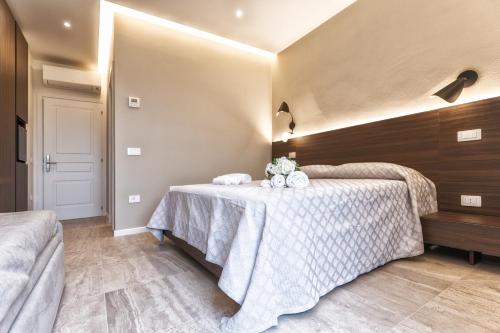 a bedroom with two beds and a table with towels at Valentino Rooms in Ravenna