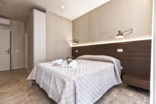 a bedroom with a bed with towels on it at Valentino Rooms in Ravenna