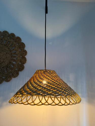 a light fixture hanging from a wall at Little jay"s villa in Batigama