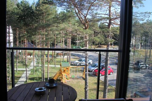 a window with a table and a view of a parking lot at Apartment Ornament Lux in Divčibare