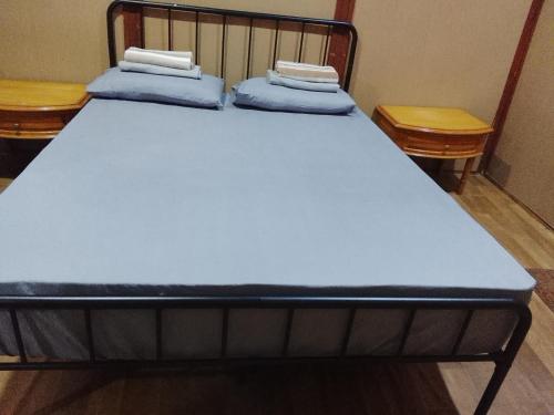 a bed with two pillows on top of it at Benteng Taman Negara in Jerantut
