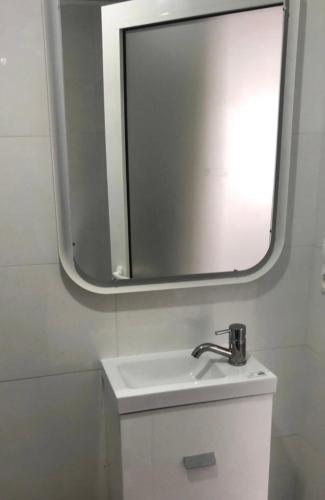 a bathroom with a sink and a mirror at Ola Bella Vista in Figueiró dos Vinhos