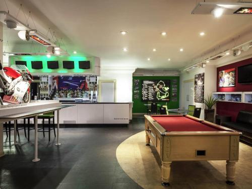 a room with a pool table and a bar at Mercure Dartford Brands Hatch Hotel & Spa in Ash