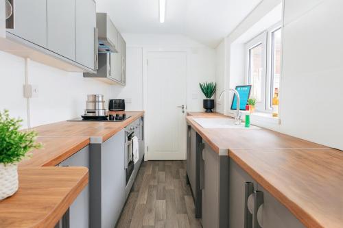 a kitchen with a counter top and a sink at Armstrong St - Cosy 3 Bedroom Home in Workington