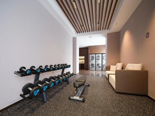 a room with a gym with weights and a couch at SINOKAI International Hotel in Maqifa