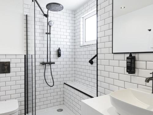 a white bathroom with a shower and a sink at Ibis Styles Lisboa Centro Liberdade NE in Lisbon