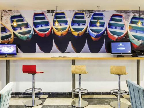 a row of boats on a wall in a store at Ibis Styles Lisboa Centro Liberdade NE in Lisbon