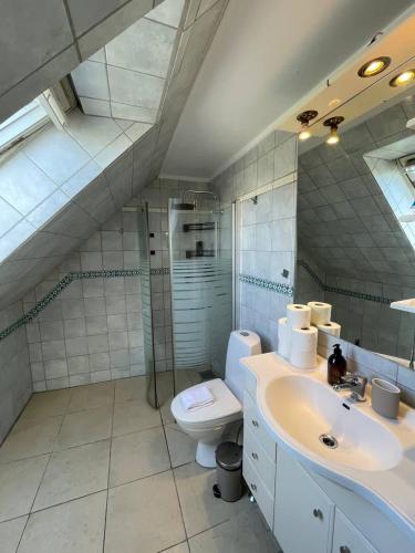 a white bathroom with a sink and a toilet at Huge private house in Amager in Copenhagen