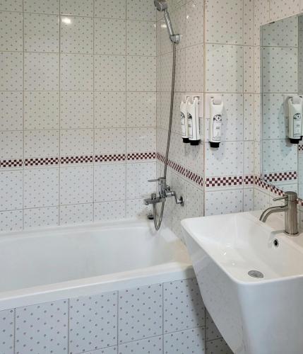 a bathroom with a white tub and a sink at jeonju hotel book and type in Jeonju