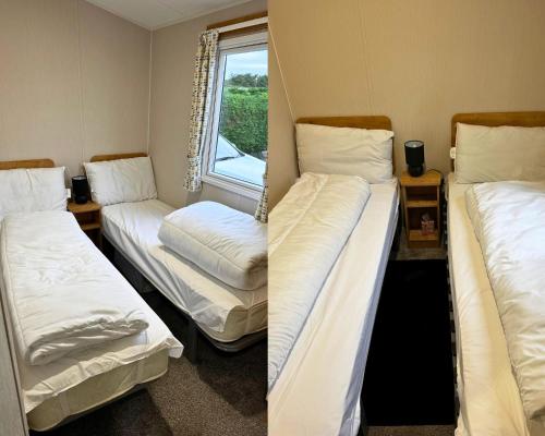 two bunk beds in a room with a window at 59 the cedarS in Winthorpe
