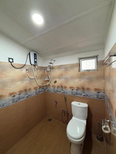 un baño con inodoro y ducha en New mahi mahi villa, en Dikwella