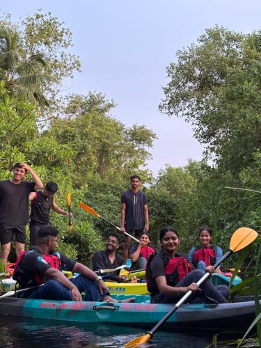 a group of people on a raft in the water at CatsClaw Inn in Talayolaparambu