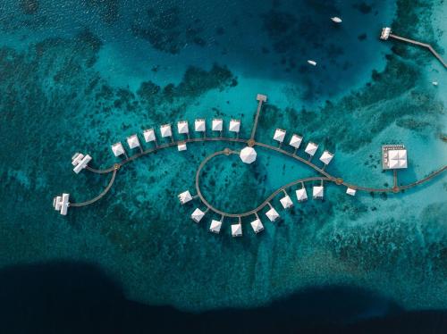 an aerial view of an island in the ocean at Diamonds Thudufushi Maldives Resort & Spa in Thundufushi