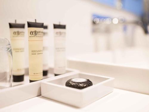 a white counter top with some cosmetic products on it at Pullman Sydney Airport in Sydney