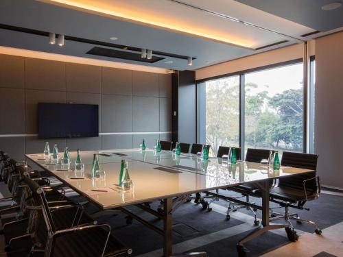 a large conference room with a long table and chairs at Pullman Sydney Airport in Sydney