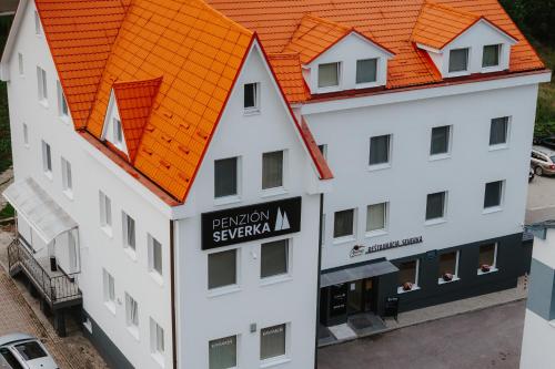 an overhead view of a white building with an orange roof at Na Orave dobre na Orave PENZIÓN SEVERKA! in Oravská Lesná
