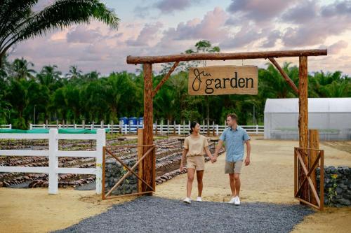a man and woman walking through a gate at a resort at Marriott Vacation Club, Khao Lak Beach Resort in Khao Lak
