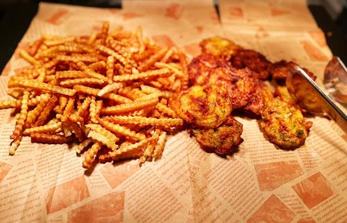 a pile of french fries and chicken tenders on a table at Magnotel Guilin Elephant Trunk Hill in Guilin