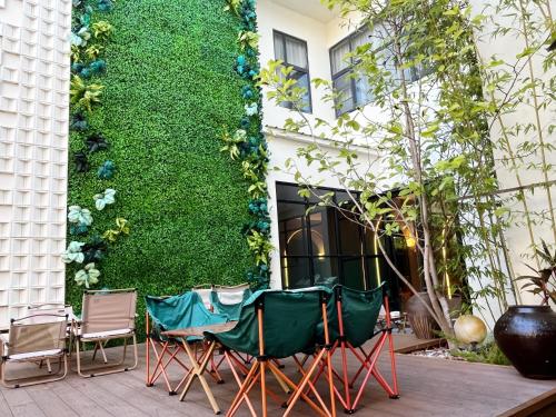 a group of chairs sitting in front of a building at Magnotel Guilin Elephant Trunk Hill in Guilin