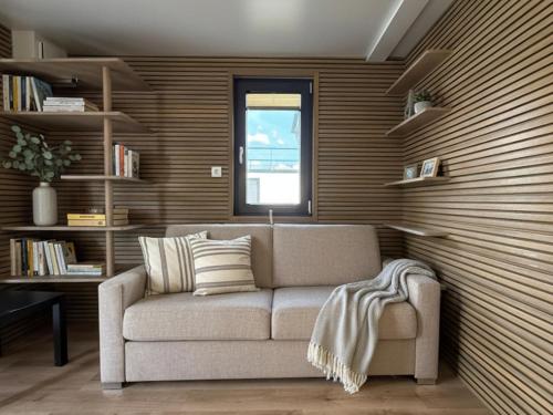 a living room with a couch and a window at Prestige Yacht Resort Budapest in Budapest