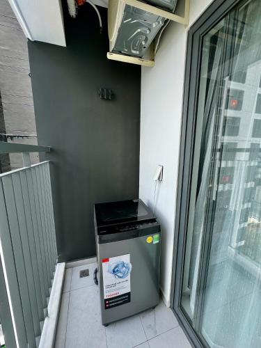 a trash can sitting next to a wall next to a window at New Lavida in Dĩ An