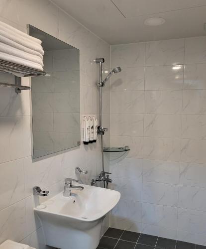 a white bathroom with a sink and a mirror at jeonju hotel book and type in Jeonju