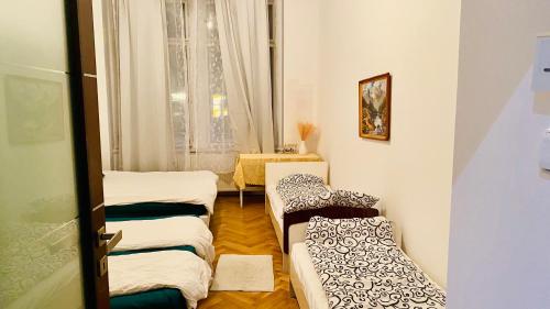 a room with three beds in it with a window at Private room in the Centre in Prague