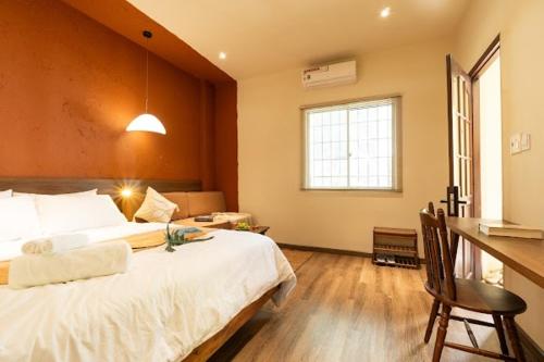 a bedroom with a large white bed and a window at PINhome in Ho Chi Minh City